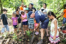 Greg demonstrating how to plant a tree.
